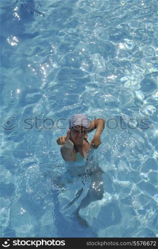 happy young woman relax at swimming pool at vacation travel resort