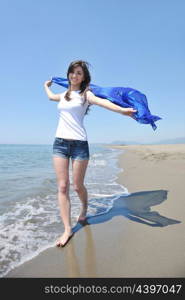 happy young woman relax on beautiful beach at fresh summer morning and enjoy first ray of sun