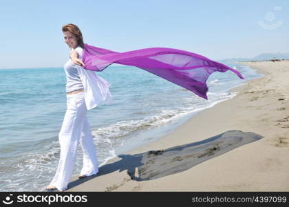 happy young woman relax on beautiful beach at fresh summer morning and enjoy first ray of sun