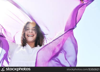 happy young woman relax on beautiful beach at fresh summer morning and enjoy first ray of sun