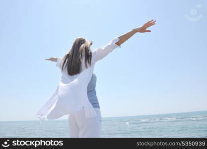 happy young woman relax on beautiful beach at fresh summer morning and enjoy first ray of sun