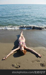 happy young woman relax on beautiful beach at fresh summer morning and enjoy first ray of sun