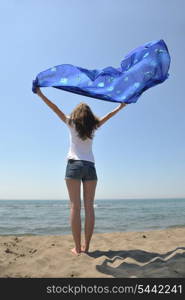 happy young woman relax on beautiful beach at fresh summer morning and enjoy first ray of sun