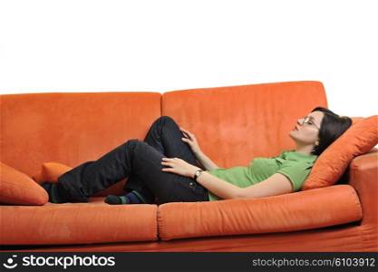 happy young woman relax on orange sofa at home isolated on white background in studio