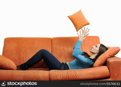 happy young woman relax on orange sofa isolated on white in studio