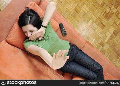 happy young woman relax on orange sofa isolated on white in studio