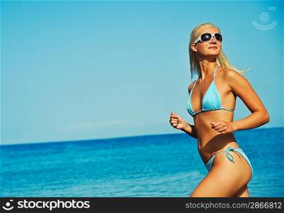 Happy young woman running in the sea