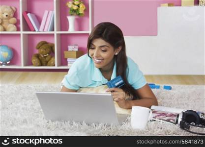 Happy young woman shopping online at home