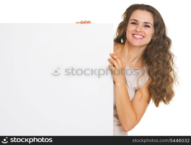 Happy young woman showing blank billboard