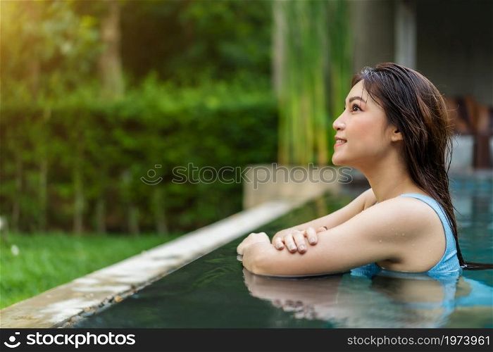 happy young woman smiling in swimming pool