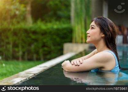 happy young woman smiling in swimming pool