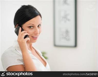 Happy young woman speaking mobile phone