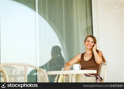 Happy young woman speaking mobile phone