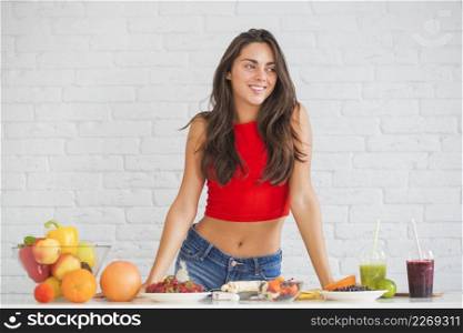happy young woman standing table with healthy food