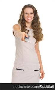 Happy young woman switching channels with tv remote control