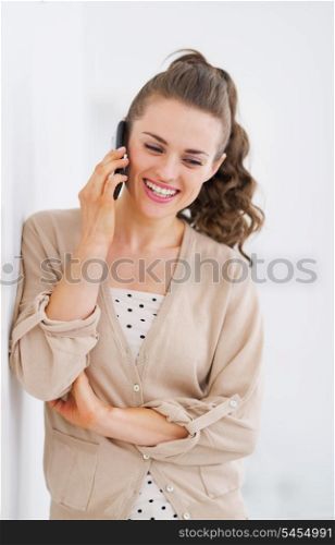 Happy young woman talking cell phone