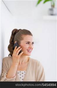 Happy young woman talking mobile phone
