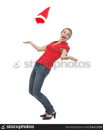 Happy young woman throwing Santa hat