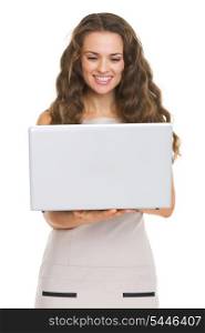 Happy young woman using laptop