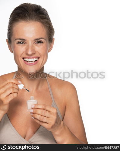 Happy young woman using nail polish