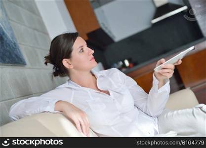 happy young woman watching tv at modern home livingroom