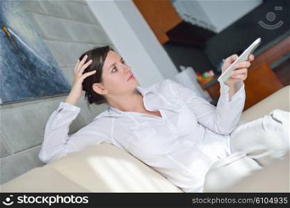 happy young woman watching tv at modern home livingroom