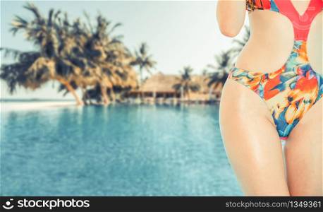Happy young woman wearing swimsuit at tropical sand beach resort in summer for holiday travel vacation.