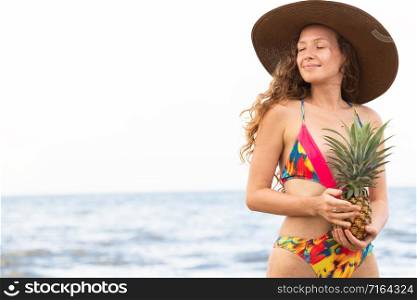 Happy young woman wearing swimsuit on tropical sand beach in summer for holiday travel vacation.. Happy woman wearing swimsuit on beach in summer