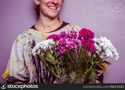 Happy young woman with a bouquet of flowers