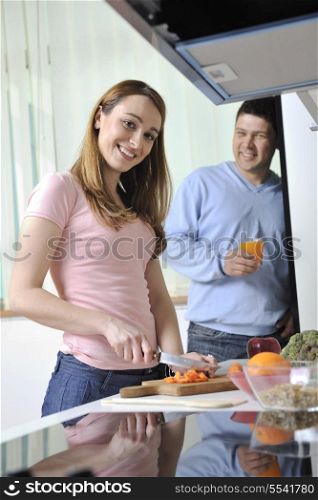 happy young woman with apple in kitchen and other food and vegetables