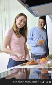 happy young woman with apple in kitchen and other food and vegetables