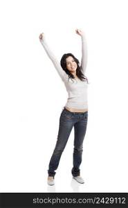 Happy young woman with arms up, isolated against a white background