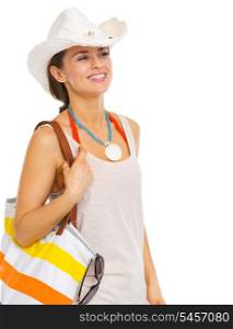 Happy young woman with beach bag looking on copy space