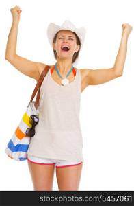 Happy young woman with beach bag rejoicing success