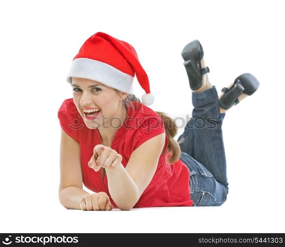 Happy young woman with Christmas hat laying on floor and pointing in camera