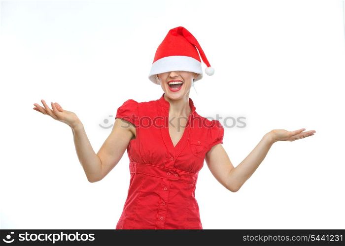 Happy young woman with Christmas hat over eyes shrugs