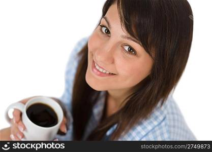Happy young woman with coffee in pajamas on white background