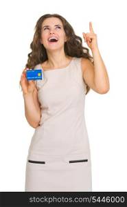 Happy young woman with credit card pointing on copy space