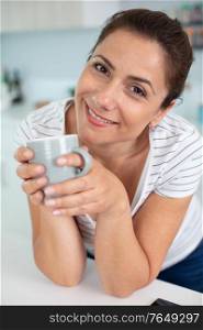 happy young woman with cup of tea or coffee