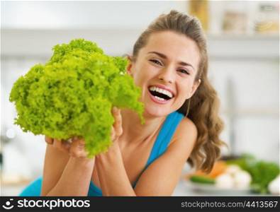 Happy young woman with fresh salad
