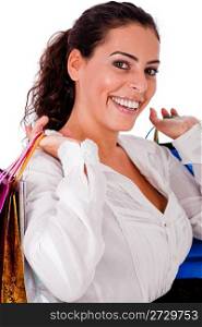 Happy young woman with shopping bag in both the hands on white isolated background