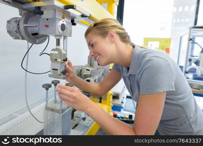 happy young woman working at factory