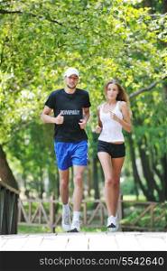 happy young younpe jogging and runing outdoor in nature at sunny day