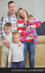 hapy young family have fun with their children at modern living room home indoors