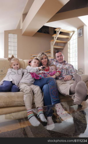 hapy young family have fun with their children at modern living room home indoors