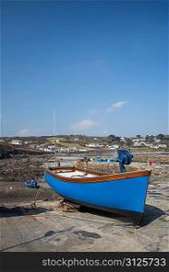 Harbour at low tide with fishing boats at Coverack England