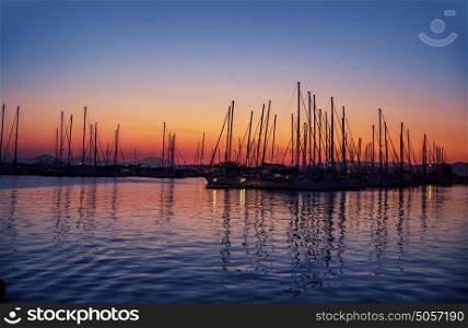 Harbour on sunset, silhouettes of luxury sailboat moored in the port in the evening, beautiful coastal view, active summer vacation