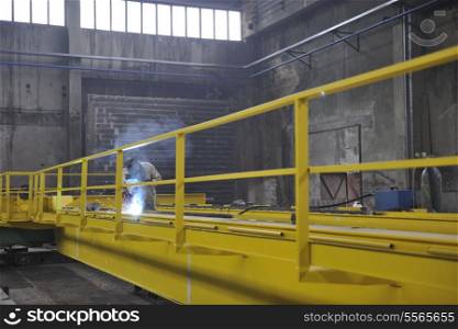 hard iron and steel industri worker working indoor in factory with weld machine