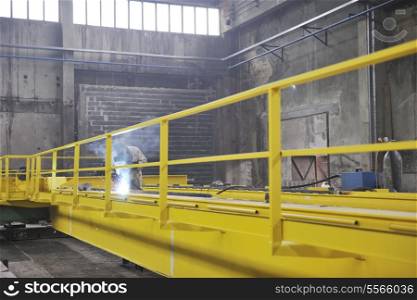 hard iron and steel industri worker working indoor in factory with weld machine