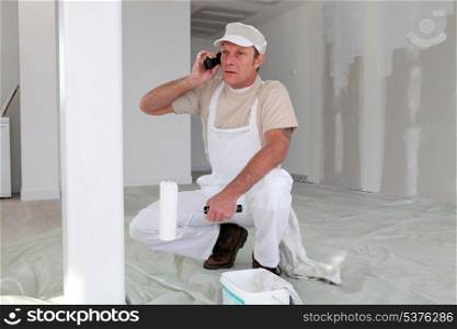 Hard-working painter talking to his client